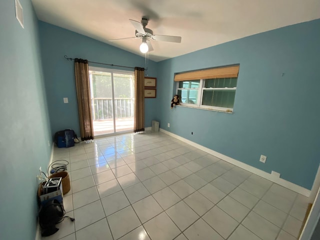 tiled spare room with lofted ceiling and ceiling fan