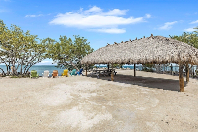 view of patio with a gazebo and a water view