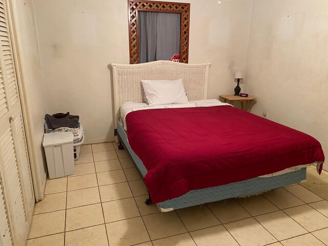 bedroom with light tile patterned floors