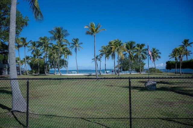 view of tennis court with a water view