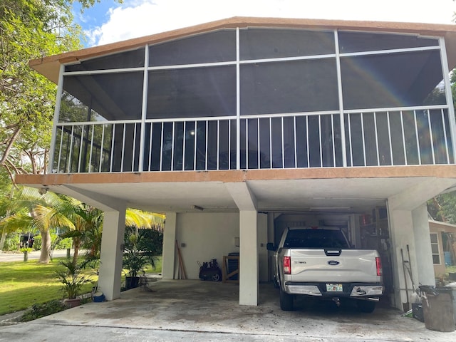 view of side of home with a carport and a sunroom