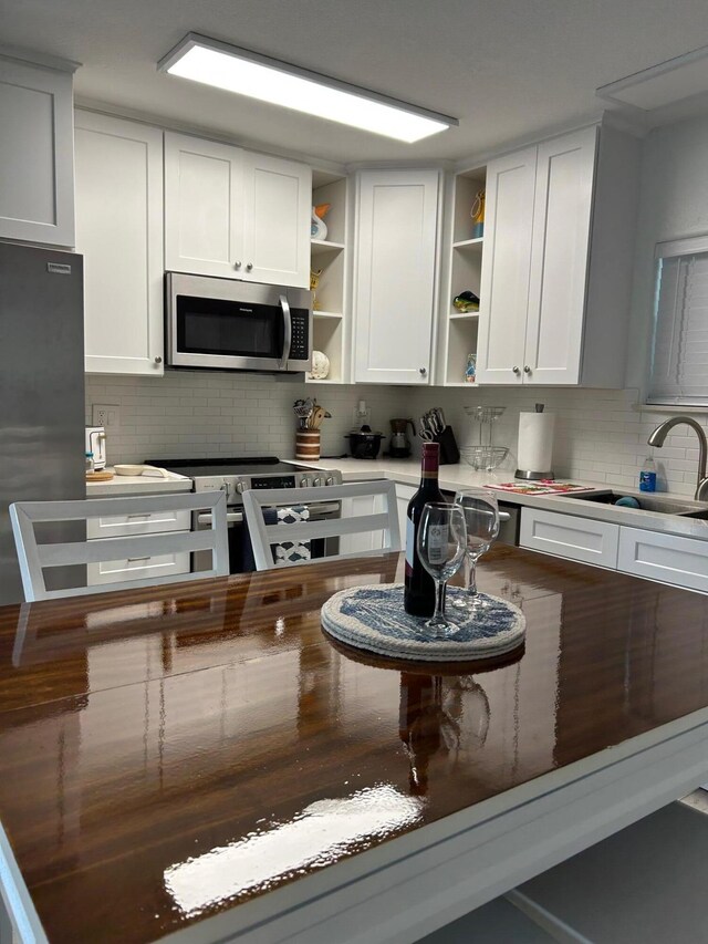 kitchen with stainless steel appliances and white cabinets