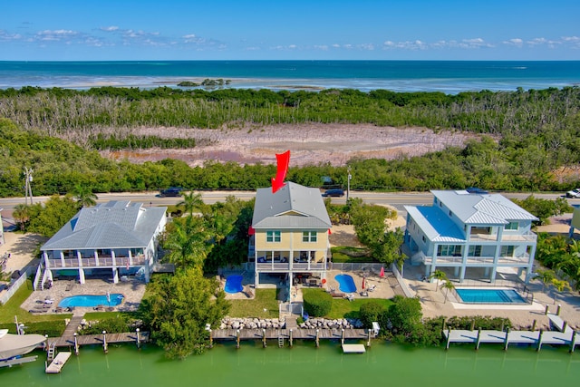 birds eye view of property with a water view