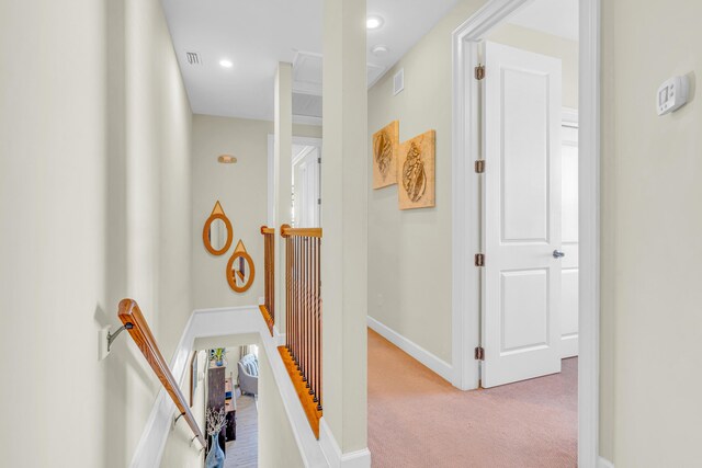 hallway featuring light colored carpet