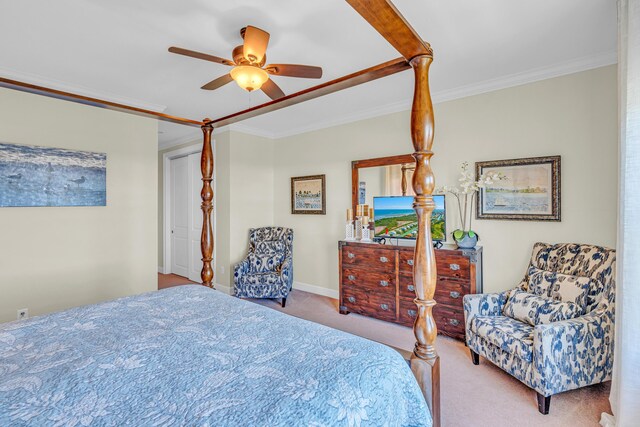 carpeted bedroom with crown molding and ceiling fan