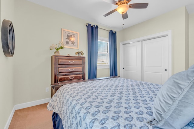 carpeted bedroom featuring ceiling fan and a closet