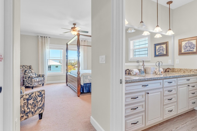 bathroom featuring vanity, ornamental molding, and ceiling fan