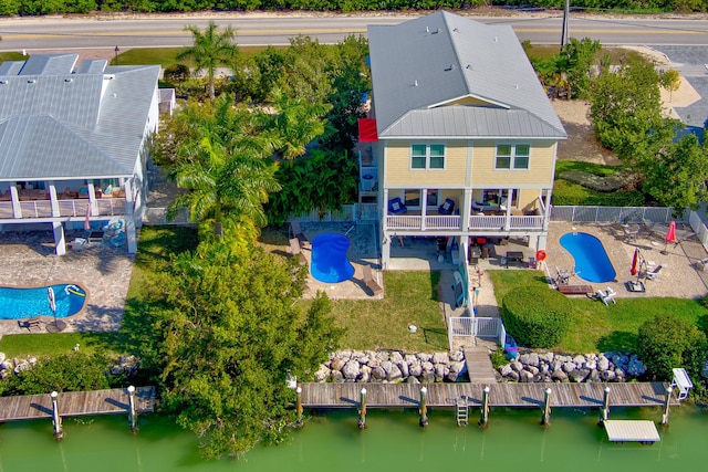 birds eye view of property with a water view