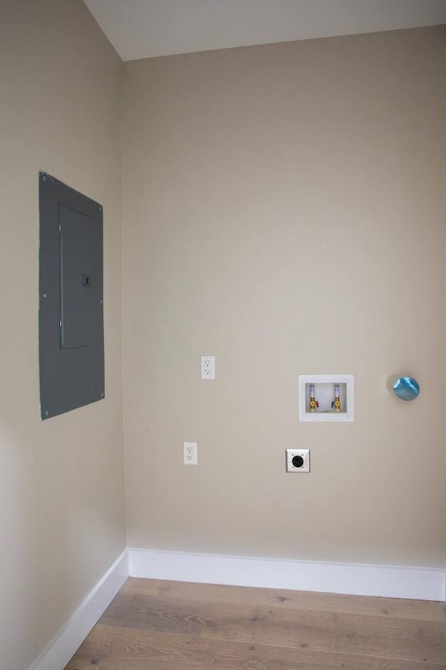 laundry area with hookup for a washing machine, electric panel, hookup for an electric dryer, and light wood-type flooring