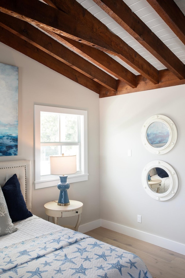 bedroom featuring lofted ceiling with beams, wooden ceiling, and light hardwood / wood-style flooring