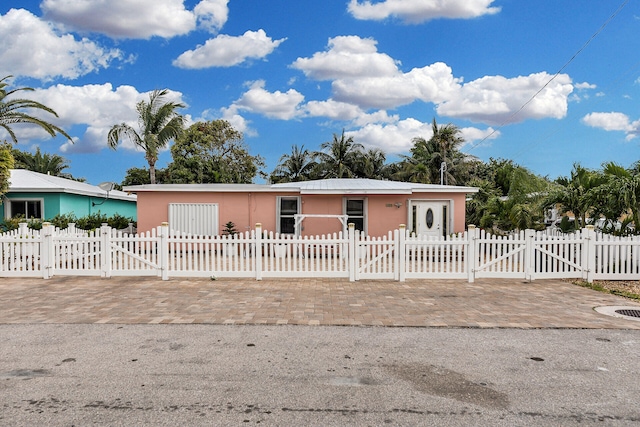 view of front of house with a fenced front yard and a gate