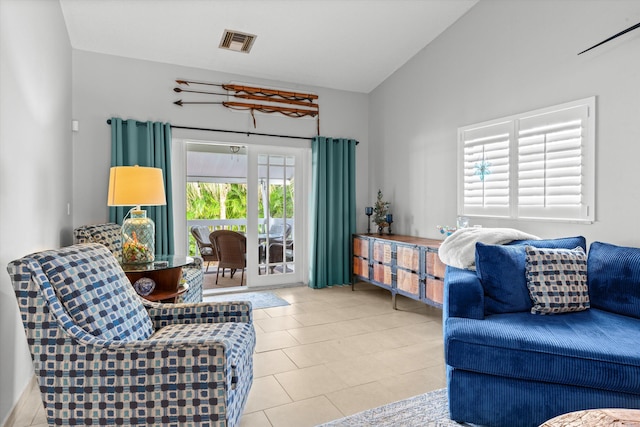 living room featuring tile patterned floors, visible vents, and vaulted ceiling