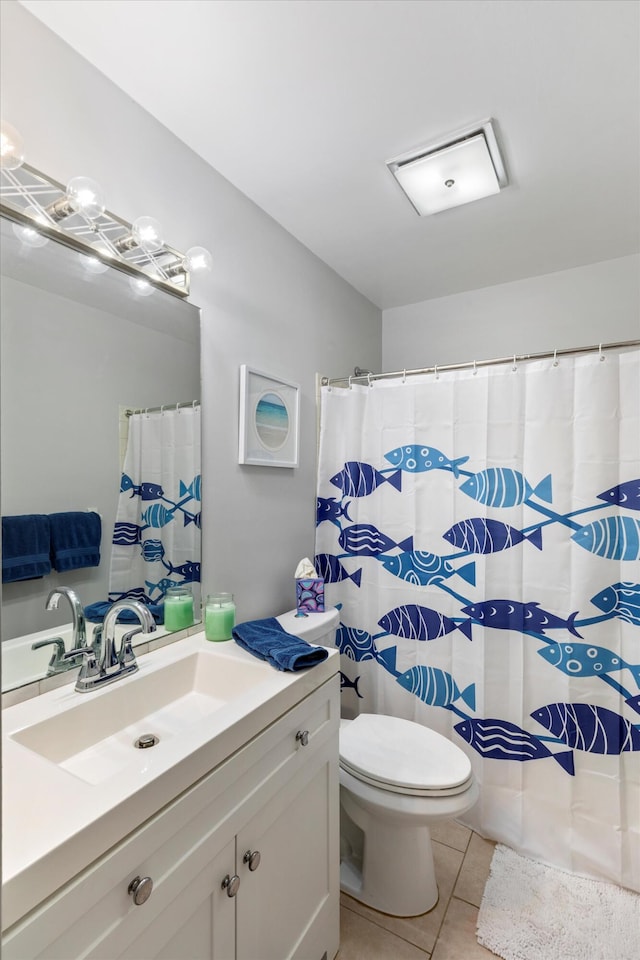 full bathroom with tile patterned floors, a shower with curtain, toilet, and vanity