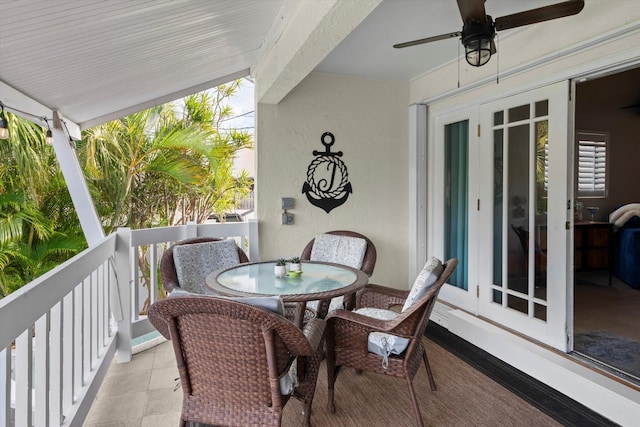 balcony with outdoor dining area and a ceiling fan