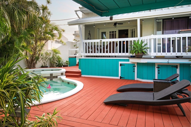 wooden terrace featuring an in ground hot tub