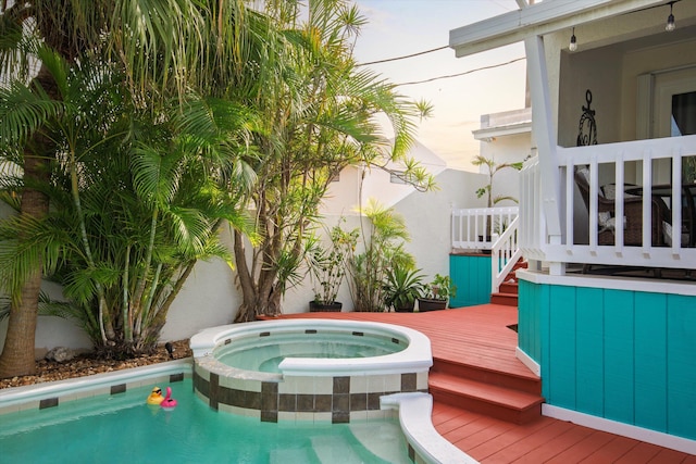 exterior space with a pool with connected hot tub