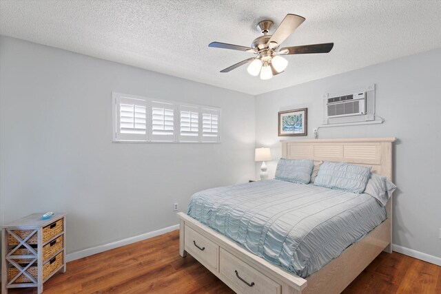 bedroom featuring a ceiling fan, wood finished floors, baseboards, and a textured ceiling