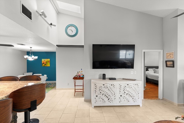 living area featuring an inviting chandelier, light tile patterned flooring, baseboards, and visible vents