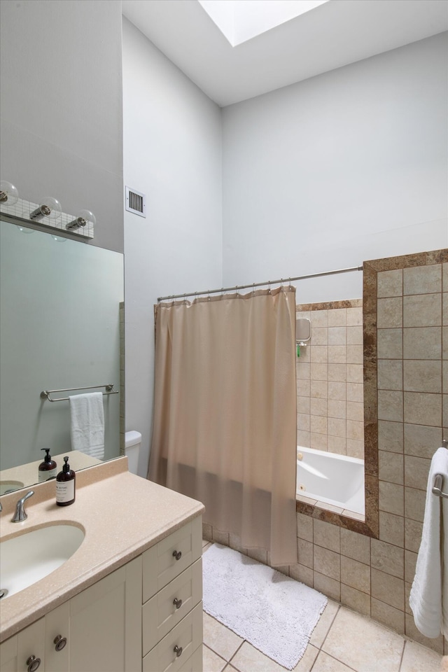 full bathroom featuring vanity, visible vents, a skylight, tile patterned floors, and tiled shower / bath