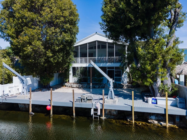 view of dock featuring stairway, a fenced backyard, and a water view