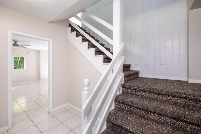 stairs featuring baseboards and tile patterned flooring