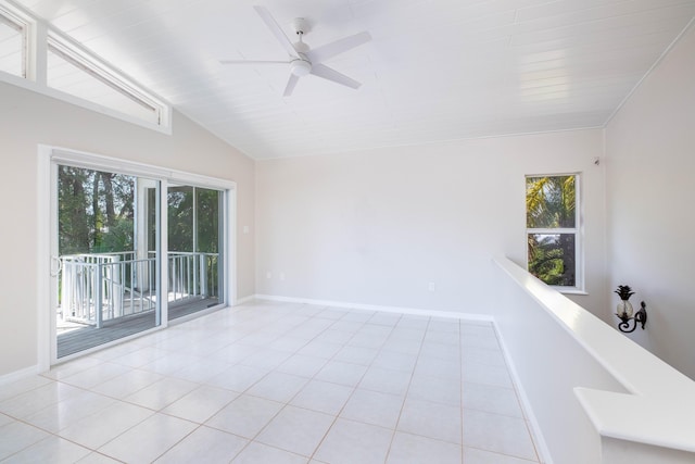 tiled empty room with baseboards, lofted ceiling, and ceiling fan