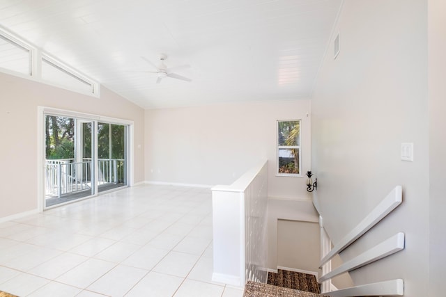 staircase featuring vaulted ceiling, tile patterned floors, visible vents, and a wealth of natural light