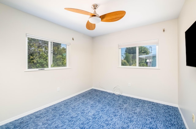 unfurnished room featuring carpet flooring, baseboards, and ceiling fan