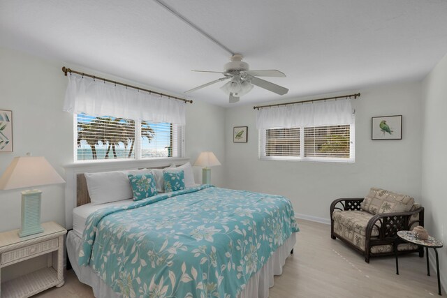 bedroom featuring light hardwood / wood-style flooring and ceiling fan