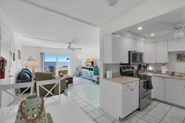 1101 W Ocean Dr Unit 1, Key Colony, FL 33051 - kitchen featuring white cabinetry, ceiling fan, appliances with stainless steel finishes, and light tile patterned floors