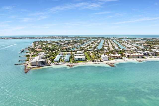 bird's eye view featuring a water view and a beach view