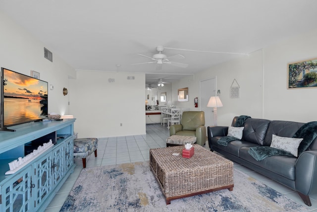 tiled living room with ceiling fan