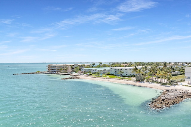 birds eye view of property featuring a water view and a view of the beach