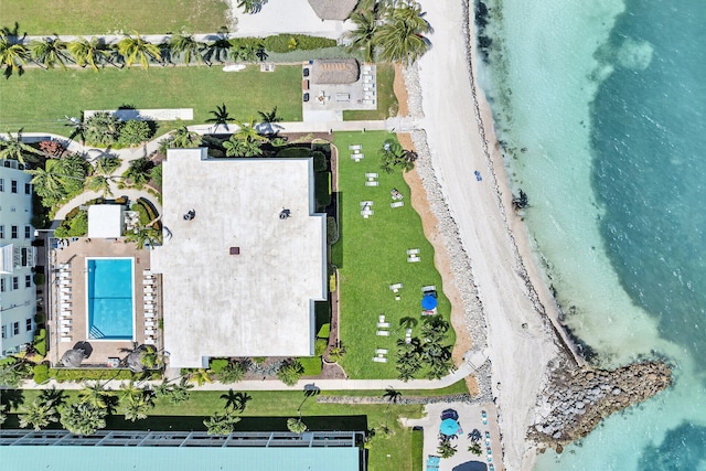 birds eye view of property featuring a water view and a beach view