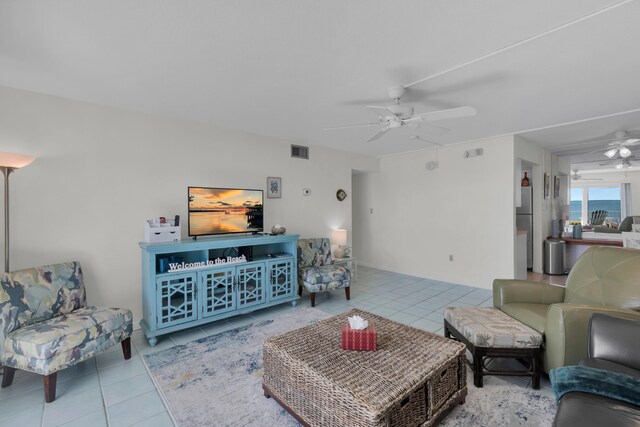 tiled living room with ceiling fan