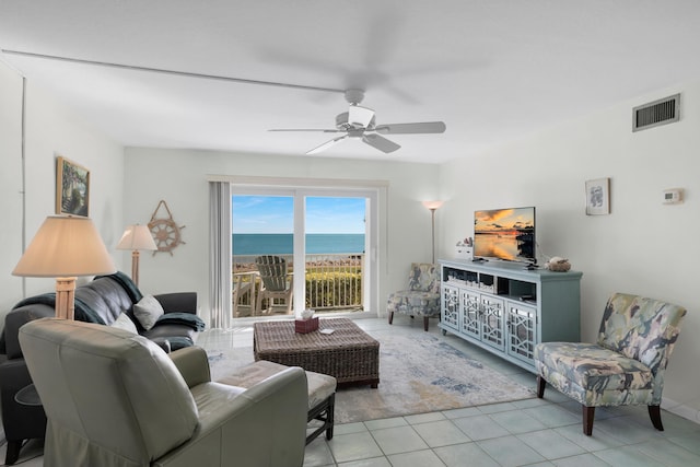 living room featuring light tile patterned floors and ceiling fan