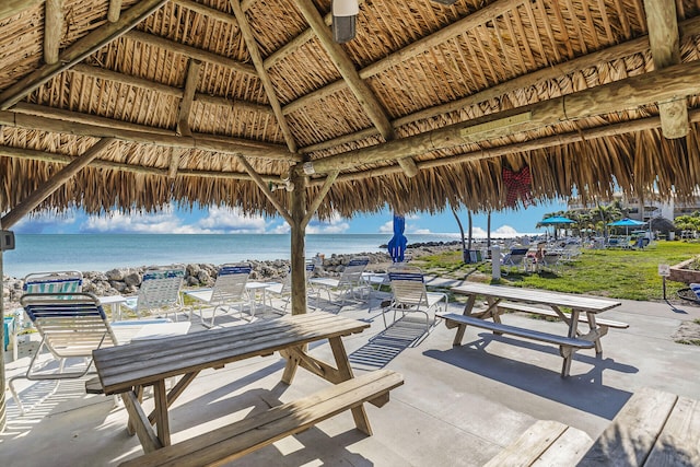 view of patio featuring a gazebo and a water view