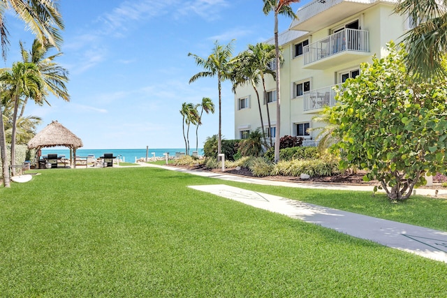 view of property's community featuring a gazebo, a water view, and a yard