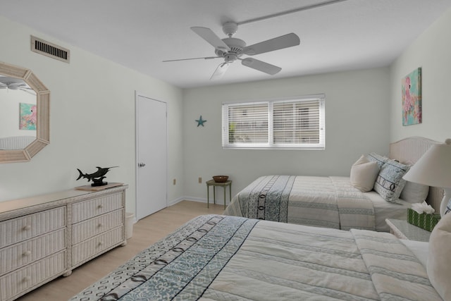 bedroom with ceiling fan and light hardwood / wood-style flooring