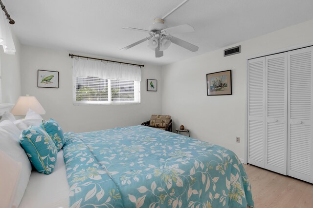 bedroom featuring ceiling fan, a closet, and light hardwood / wood-style flooring