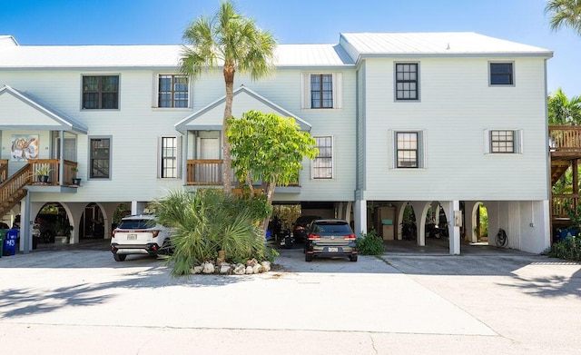 3314 Northside Dr Unit 46, Key West, FL 33040 - rear view of property with a carport, driveway, and a metal roof