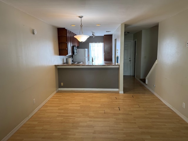 3314 Northside Dr Unit 46, Key West, FL 33040 - kitchen with open shelves, freestanding refrigerator, light wood-style floors, and hanging light fixtures
