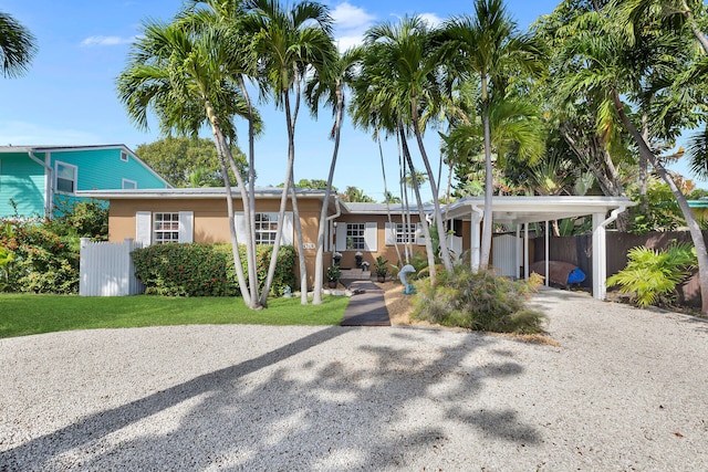 view of front facade with a carport and a front yard