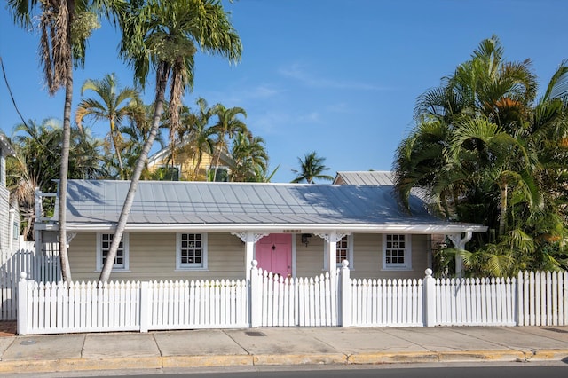 1116 Eaton St, Key West, FL 33040 - view of front of house with a fenced front yard and a metal roof