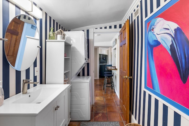1116 Eaton St, Key West, FL 33040 - bathroom featuring stacked washing machine and dryer, wallpapered walls, and vanity