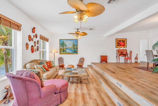 living room featuring ceiling fan, wood finished floors, and visible vents