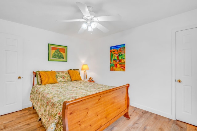 bedroom with baseboards, ceiling fan, and light wood finished floors