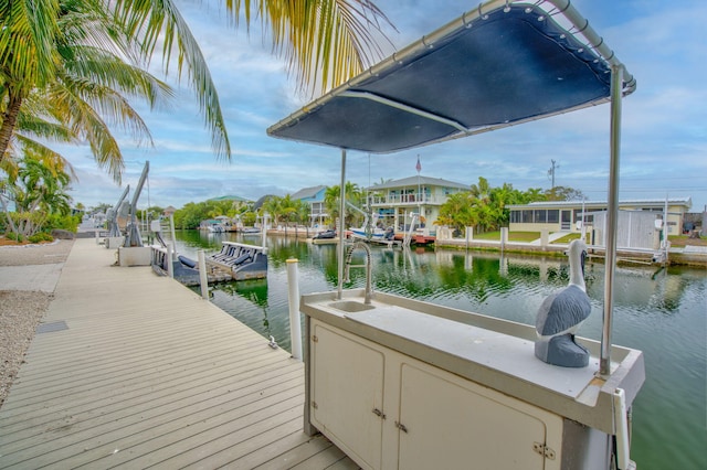 view of dock with a water view and a sink