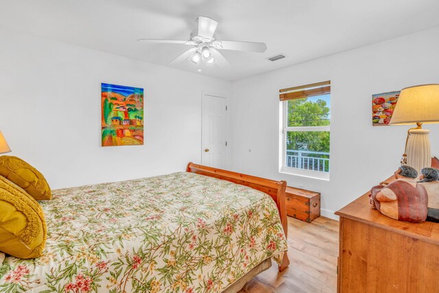 bedroom with light wood-type flooring, ceiling fan, and visible vents