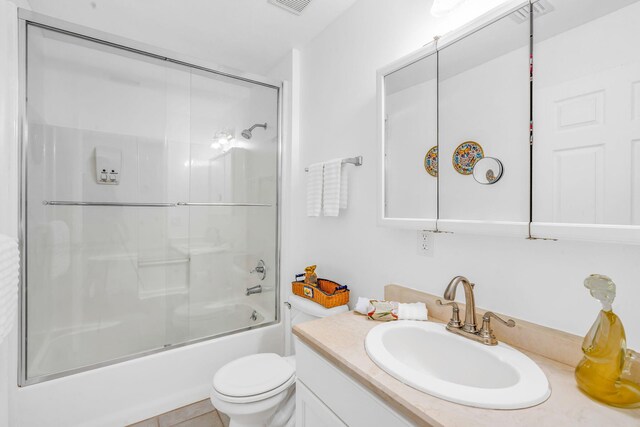 bathroom with tile patterned flooring, a shower with door, and toilet